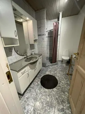 a bathroom with a sink and a shower at Cozy base near the cathedral in Viborg