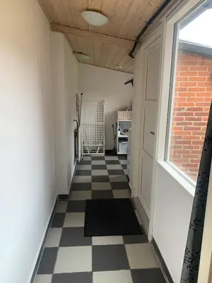 a hallway with a checkered floor and a window at Townhouse centrally located close to Jesperhus in Nykøbing Mors