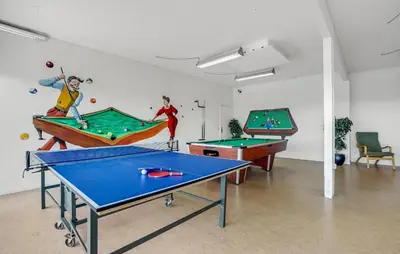 a room with two ping pong tables and billards at Amazing Home In Vestervig With Sauna in Vestervig