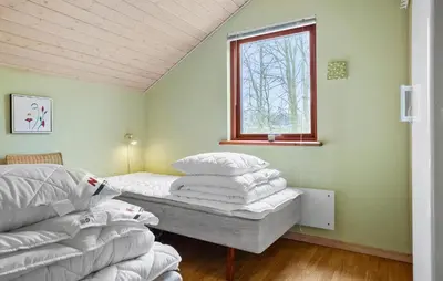 a bedroom with a bed and a window at Cozy Home In Spøttrup With Sauna in Spottrup