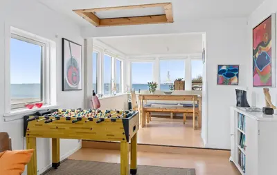 a living room with a table with a chess board at Nice Home In Øster Assels in Øster Assels