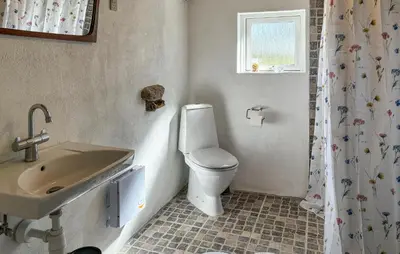 a bathroom with a toilet and a sink at 1 Bedroom Gorgeous Home In Spøttrup in Spottrup