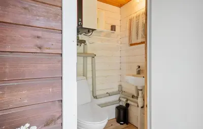 a bathroom with a toilet and a sink at 3 Bedroom Stunning Home In Spøttrup in Spottrup