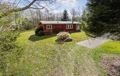 a red house in the middle of a yard at 3 Bedroom Stunning Home In Spøttrup in Spottrup