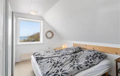 a bedroom with a bed and a window at 2 Bedroom Stunning Home In Øster Assels in Øster Assels