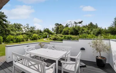 a patio with a white table and chairs on a deck at Stunning Home In Fjerritslev With Sauna in Fjerritslev