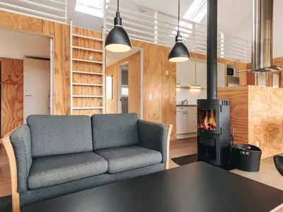a living room with a couch and a stove at 4 star holiday home in Brovst in Brovst