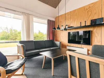 a living room with a couch and a table at 4 star holiday home in Brovst in Brovst