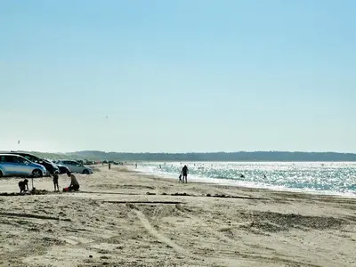 a group of people standing on a beach at 4 star holiday home in Brovst in Brovst