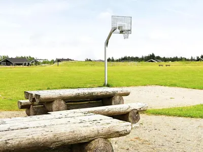 a bench and a basketball hoop with a basket at 4 star holiday home in Brovst in Brovst