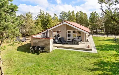 a small cabin with a deck in a yard at Stunning Home In Hurup Thy With Sauna in Sønder Ydby