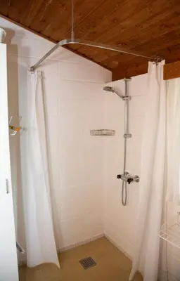 a bathroom with a shower with a shower curtain at Dune House Near Bulbjerg in Frøstrup