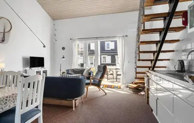 a kitchen and living room with chairs and a ladder at Stunning Home In Vestervig With Sauna in Vestervig