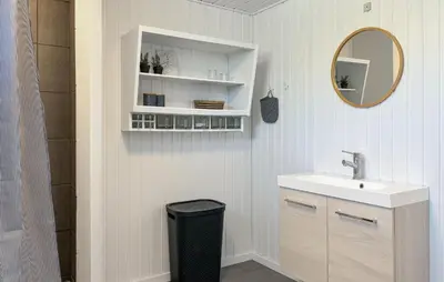 a bathroom with a sink and a mirror at 3 Bedroom Nice Home In Fjerritslev in Fjerritslev