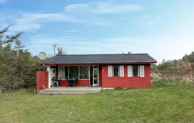 a red tiny house with a deck in a field at Lovely Home In Fjerritslev With Wifi in Fjerritslev