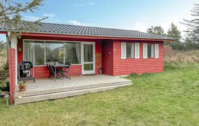 a red tiny house with a wooden porch at Lovely Home In Fjerritslev With Wifi in Fjerritslev