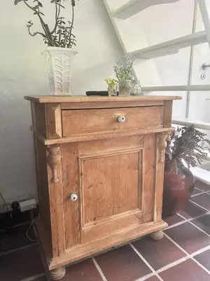 a wooden cabinet with two vases on top of it at PipOp - the place where you find your soul again in Struer