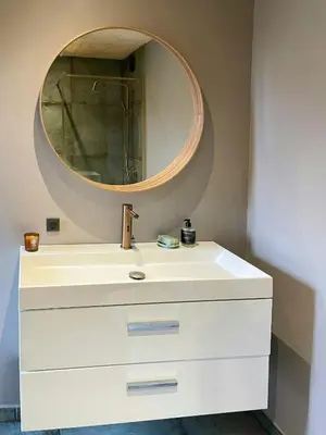 a bathroom with a white sink and a mirror at Modern Wooden House Near Halkær Bredning in Nibe