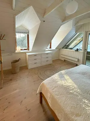 a bedroom with an attic with a bed and windows at Hidden Gem By Thy National Park