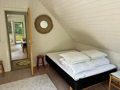 a bed with pillows in a room with a staircase at Hidden Gem By Thy National Park