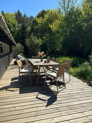 a wooden deck with a table and chairs on it at Hidden Gem By Thy National Park