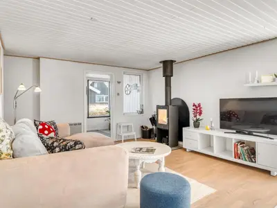 a living room with a couch and a tv at Holiday Home Mynthe - 500m from the sea by Interhome in Thisted
