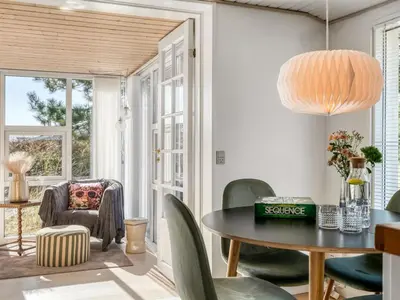 a dining room with a table and chairs at Holiday Home Mynthe - 500m from the sea by Interhome in Thisted