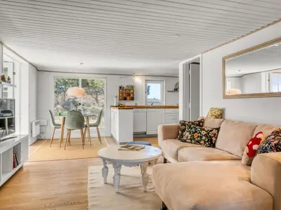 a living room with a couch and a table at Holiday Home Mynthe - 500m from the sea by Interhome in Thisted