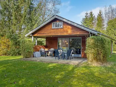 a cabin with a table and chairs in a yard at Holiday Home Franzisca - 200m to the fjord by Interhome in Roslev