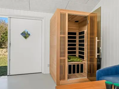 a door to a wine cellar with an umbrella at Holiday Home Jork - 1km from the sea by Interhome in Saltum