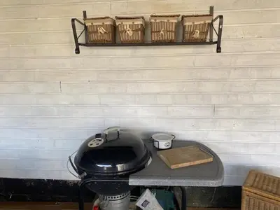 a table with a toilet and baskets on a wall at Dejlig gårdhave 5 soveværelser in Harboør