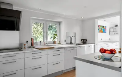a white kitchen with white cabinets and a bowl of apples at 3 Bedroom Pet Friendly Home In Løkken in Løkken