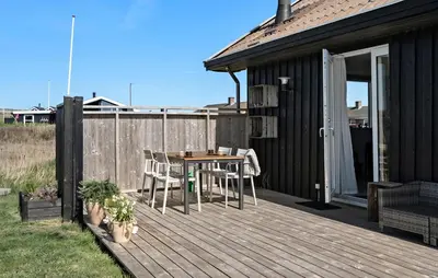 a wooden deck with a table and chairs on it at 3 Bedroom Gorgeous Home In Lemvig in Lemvig