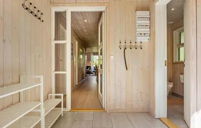 a hallway of a house with wooden walls at 3 Bedroom Nice Home In Farsø in Farsø