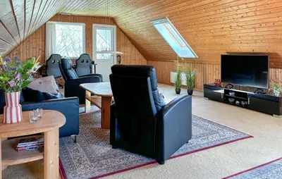 a living room with a couch and a tv at Nice Home In Roslev With Wifi in Roslev