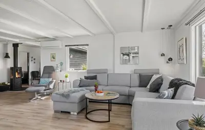 a living room with a couch and a table at 3 Bedroom Cozy Home In Vinderup in Vinderup