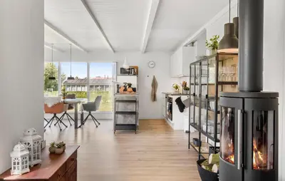 a living room with a fireplace and a dining room at 3 Bedroom Cozy Home In Vinderup in Vinderup