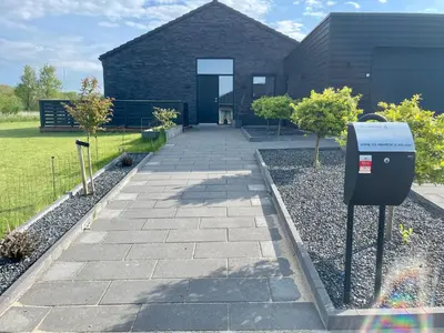 a parking meter in front of a house at Moderne bynært hus in Holstebro