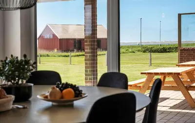 a table and chairs with a bowl of fruit on it at Awesome Home In Vestervig With Sauna in Vestervig