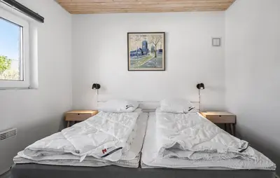 two beds in a white room with two lamps at Awesome Home In Vestervig With Sauna in Vestervig
