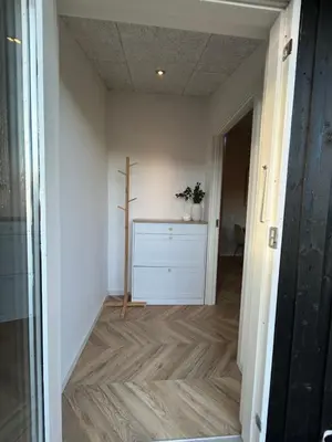 a hallway with a cross on the wall at Nyrenoveret,hyggeligt og centralt hus in Holstebro