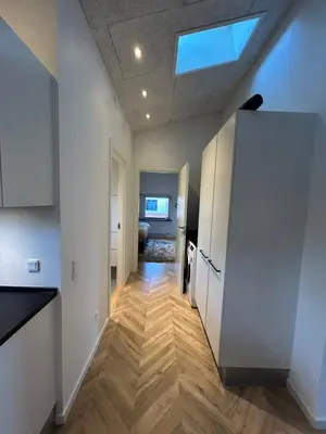 a hallway with a kitchen with a skylight at Nyrenoveret,hyggeligt og centralt hus in Holstebro