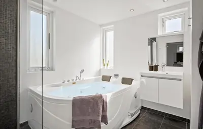 a white bathroom with a tub and a sink at Gorgeous Home In Brovst With Sauna in Brovst