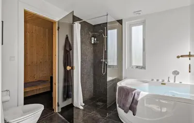 a bathroom with a tub and a toilet and a sink at Gorgeous Home In Brovst With Sauna in Brovst