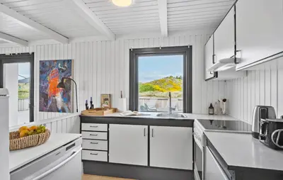 a white kitchen with a sink and a window at 4 Bedroom Cozy Home In Saltum in Saltum