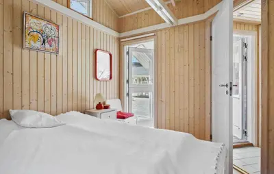 a bedroom with a white bed and a window at 3 Bedroom Beautiful Home In Blokhus in Blokhus