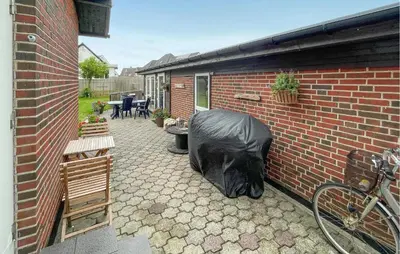a black gorilla head laying on the side of a brick building at Cozy Home In Thyborøn With Wifi in Thyborøn