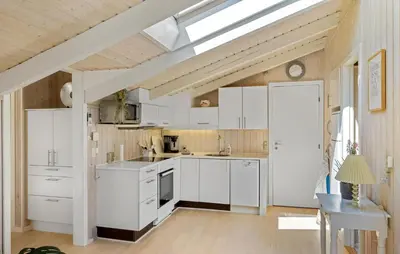 a kitchen with white cabinets and a skylight at 3 Bedroom Beautiful Home In Blokhus in Blokhus