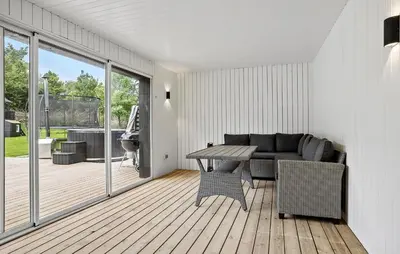 a living room with a couch and a table at 3 Bedroom Stunning Home In Spøttrup in Spottrup