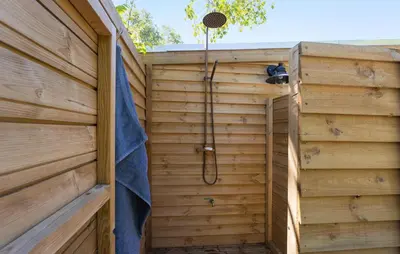 a sauna with a shower in a wooden wall at Beautiful Home In Fur With Wifi in Fur